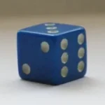 A blue dice with six dots on it.